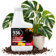 A white plastic bottle of GrowScripts 936 Plant Food Fertilizer with a black, red, and orange label, styled in front of a potted variegated Monstera plant on soil.